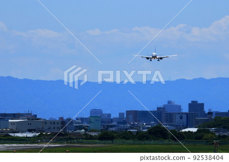 Osaka International Airport, a passenger plane taking off and landing Osaka International Airport, a passenger plane taking off and landing 92538404