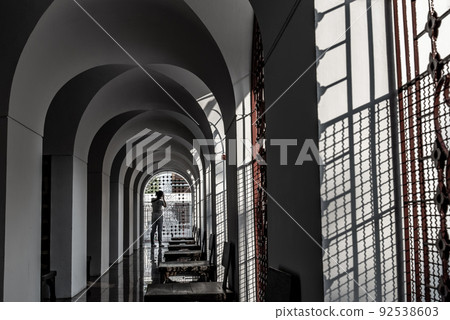 A Woman takes pictures with a camera inside the Metal Palace, Metal Castle at Wat Ratchanaddaram. A Woman takes pictures with a camera inside the Metal Palace, Metal Castle at Wat Ratchanaddaram. 92538603