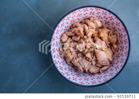 Stir fried chicken with black soy sauce in a japanese bowl on green iron tray, asian homemade style food concept, Oblique view from the top. Stir fried chicken with black soy sauce in a japanese bowl on green iron tray, asian homemade style food concept, Oblique view from the top. 92539711