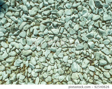 texture, small, gray stones lie on the road. material for the construction of roadsides and roads, stones for decorative figures texture, small, gray stones lie on the road. material for the construction of roadsides and roads, stones for decorative figures 92540626