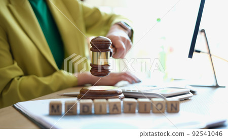 Female hand striking gavel in court room 92541046
