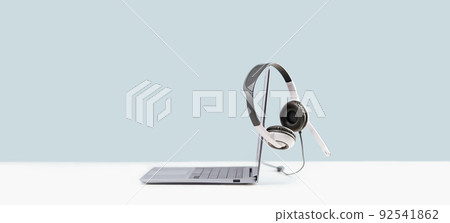 Laptop with headphones on white desk wide banner Laptop with headphones on white desk wide banner 92541862