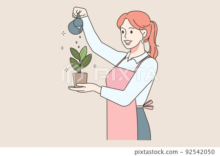Happy woman watering plant 92542050