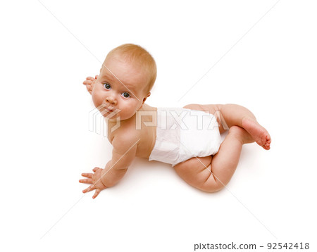 A tanned Caucasian baby in a white diaper crawls on his hands and looks up. View from above. Isolated on a white background 92542418