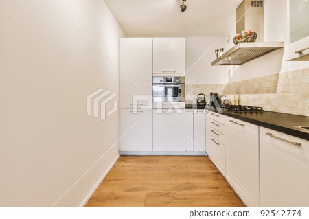 Couches and table located near dining area of spacious room with kitchen in contemporary apartment Couches and table located near dining area of spacious room with kitchen in contemporary apartment 92542774