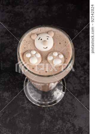 cocoa drink decorated with funny cookies on a dark background cocoa drink decorated with funny cookies on a dark background 92542824