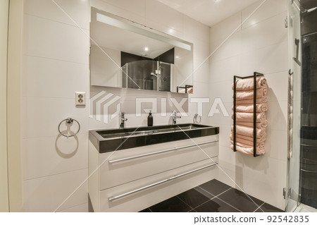 Black wall hung toilet in minimalist interior of bathroom with shower cabin 92542835