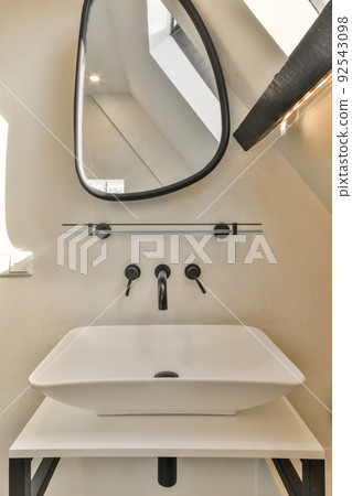 Sink with tap and liquid soap hanging on tiled wall under mirror in contemporary restroom at home Sink with tap and liquid soap hanging on tiled wall under mirror in contemporary restroom at home 92543098