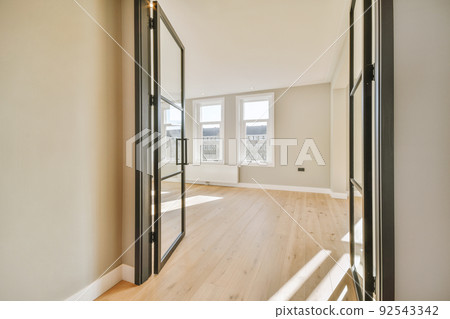 Plastic window and radiator on white wall in empty light room at home Plastic window and radiator on white wall in empty light room at home 92543342