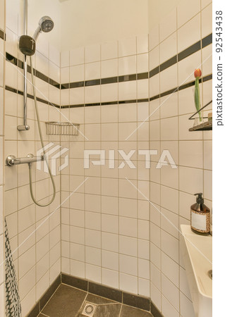 Interior of contemporary bathroom with shower and toilet in minimal style in flat 92543438