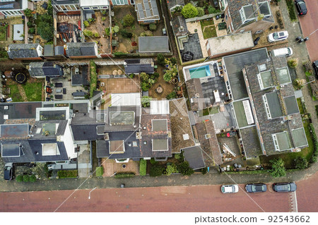 Panorama view of brick houses from an empty sidewalk street with cars, trees and lanterns Panorama view of brick houses from an empty sidewalk street with cars, trees and lanterns 92543662
