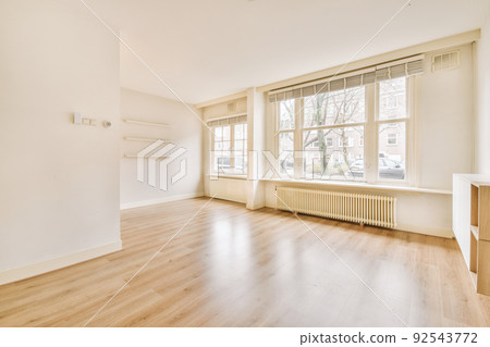Plastic window and radiator on white wall in empty light room at home Plastic window and radiator on white wall in empty light room at home 92543772