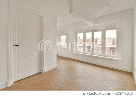 Interior of empty white room with windows and wooden parquet floor Interior of empty white room with windows and wooden parquet floor 92544168