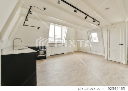 A cozy and spacious mansard styled empty room in a luxury house 92544465