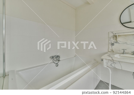 Interior of contemporary bathroom with shower and sink in minimal style in flat 92544864