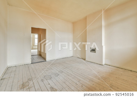 Plastic window and radiator on white wall in empty light room at home Plastic window and radiator on white wall in empty light room at home 92545016