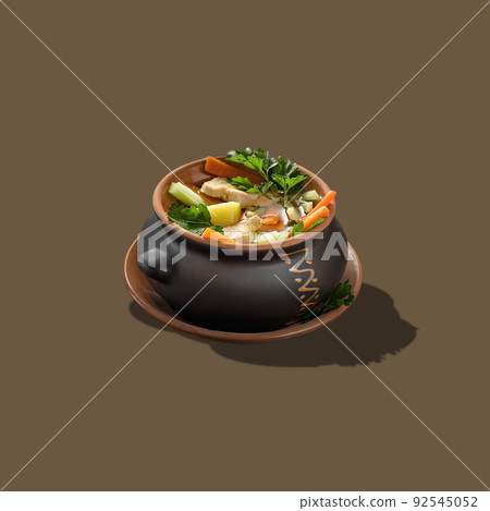 Meat with vegetables in a black baking pot isolated on a brown background. Meat with vegetables in a black baking pot isolated on a brown background. 92545052