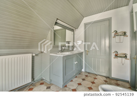 Modern home interior design of white bathroom with open bathtub and shower separated from toilet by partition wall Modern home interior design of white bathroom with open bathtub and shower separated from toilet by partition wall 92545139