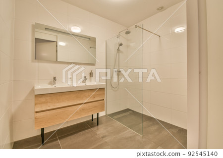Stylish bathroom interior design with white toilet and bathtub with glass shower in modern apartment Stylish bathroom interior design with white toilet and bathtub with glass shower in modern apartment 92545140
