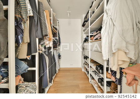 White wardrobe with mirrors located near guitar and cabinet in light room at home White wardrobe with mirrors located near guitar and cabinet in light room at home 92545142