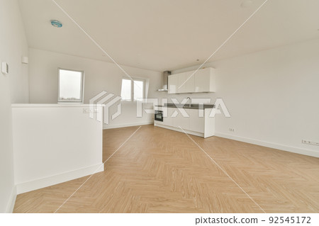 Interior of empty white kitchen with windows and wooden parquet floor Interior of empty white kitchen with windows and wooden parquet floor 92545172