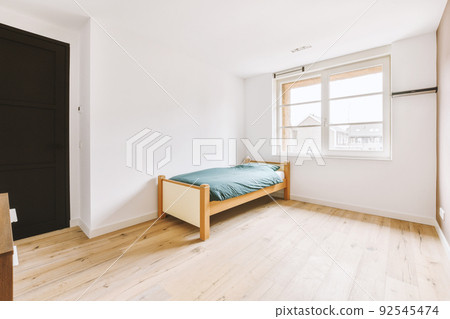 Comfortable bed without ornamental blanket, near window and wardrobe in light bedroom Comfortable bed without ornamental blanket, near window and wardrobe in light bedroom 92545474