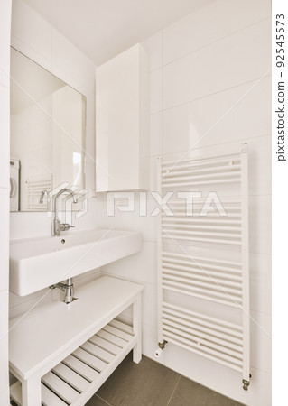 Sink with tap and liquid soap hanging on tiled wall under mirror in contemporary restroom at home Sink with tap and liquid soap hanging on tiled wall under mirror in contemporary restroom at home 92545573