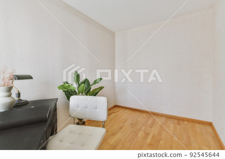 Comfortable chair placed near table with against blank whiteboard and mirror in light home office in contemporary flat 92545644