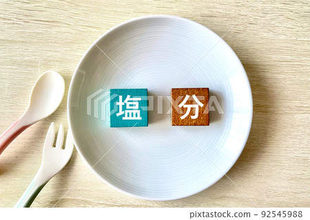 Salt spoon and fork on the plate 92545988