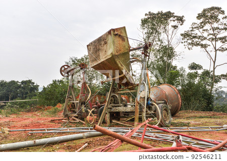 Rusty and worn concrete mixer abandoned outdoors 92546211