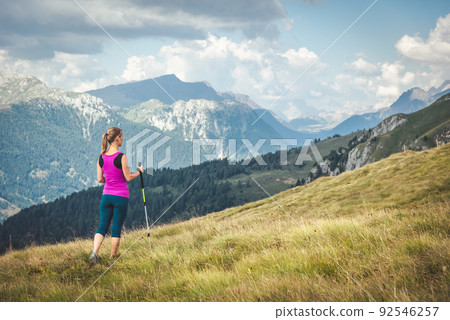 Young woman hiking in the mountains Young woman hiking in the mountains 92546257