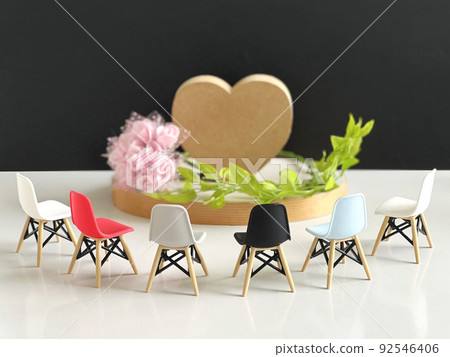 Image of a chair that surrounds heart accessories and flowers and leaves 92546406