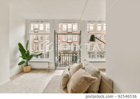 Shabby wooden table with chairs and vase located near comfortable couch against light walls with decorations and TV in modern apartment Shabby wooden table with chairs and vase located near comfortable couch against light walls with decorations and TV in modern apartment 92546536