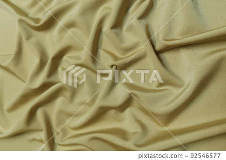 Gold supplex crumpled or wavy fabric texture background. Abstract linen cloth soft waves. Silk fabric. Smooth elegant luxury cloth texture. Concept for banner or advertisement. Gold supplex crumpled or wavy fabric texture background. Abstract linen cloth soft waves. Silk fabric. Smooth elegant luxury cloth texture. Concept for banner or advertisement. 92546577