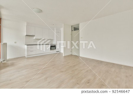 Interior of empty white kitchen with windows and wooden parquet floor 92546647