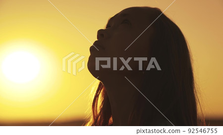 teenage dream sunset sky. girl believes in God. pray think rays sunlight. face child girl looking up. close your eyes looking sky. daughter kid dreams sunset. children religion. freedom true sleep. 92546755