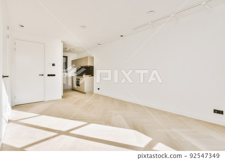 Interior of empty white kitchen with windows and wooden parquet floor 92547349