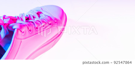 Closeup female sports shoes, sneakers isolated over neoned background. Urban city fashion, fitness, sport, training concept. Closeup female sports shoes, sneakers isolated over neoned background. Urban city fashion, fitness, sport, training concept. 92547864