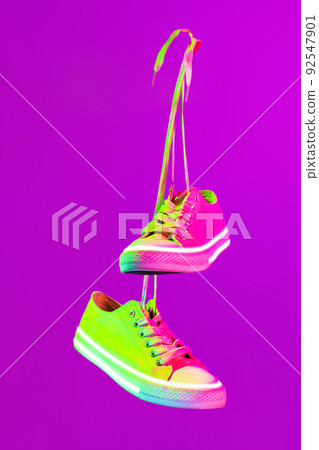 Modern sports shoes over neoned background. Sneakers or trainers isolated. Athletic shoes. fitness, sport, training concept. Urban fashion Modern sports shoes over neoned background. Sneakers or trainers isolated. Athletic shoes. fitness, sport, training concept. Urban fashion 92547901