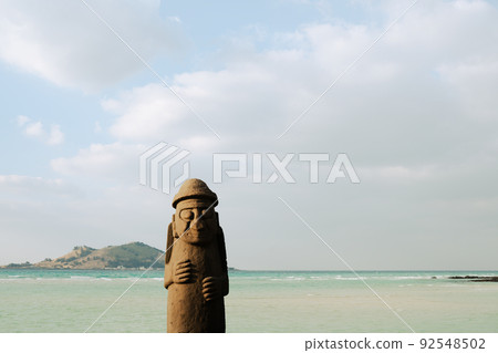 Geumneung Beach and Dolhareubang stone grandpa in Jeju island, Korea Geumneung Beach and Dolhareubang stone grandpa in Jeju island, Korea 92548502