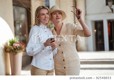 Two elegant female tourists seeing the sights Two elegant female tourists seeing the sights 92548653