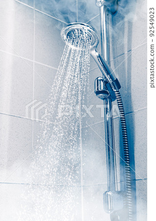 contrast shower with flowing water and steam, blue background 92549023