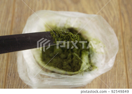 at the tip of the knife 1 dose powder carcinogenic chewing tobacco (nas, nasvay, dip, snus ) from Tajikistan, against the background of the complete package of this semi-legal substance 92549849