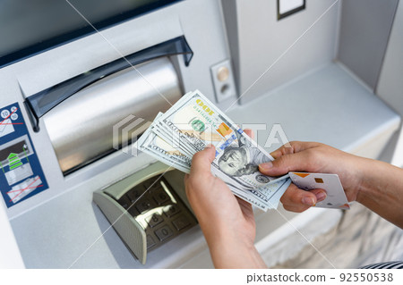 Atm cash machine money. Woman withdraw money dollar bill. Holding american hundred cash. Money dollar, bank credit card. 92550538