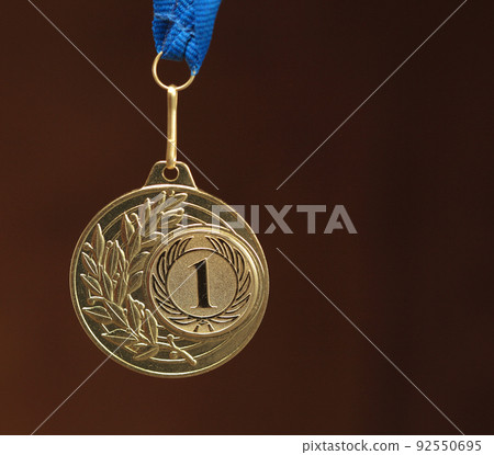 gold medal on brown background 92550695