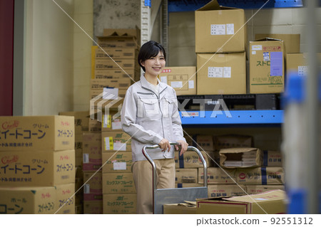 Business scene: A woman working in a warehouse 92551312