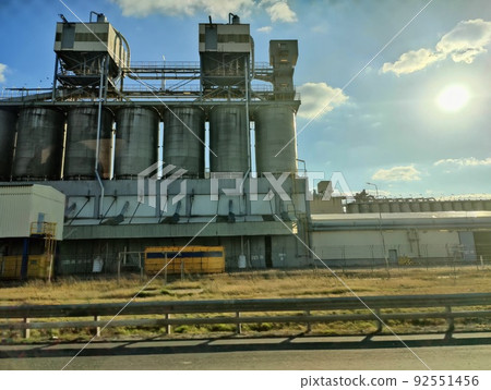 Oil storage tank terminal and tanker, petrol industrial zone shot from a moving car Oil storage tank terminal and tanker, petrol industrial zone shot from a moving car 92551456