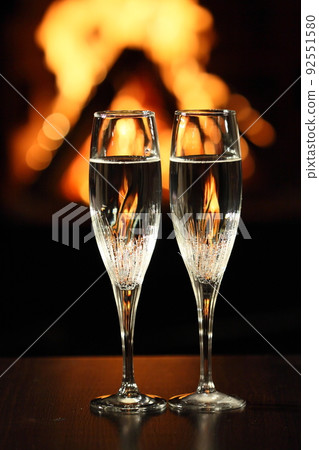two glasses in front of fireplace two glasses in front of fireplace 92551580