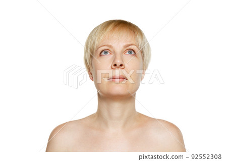 Portrait of beautiful middle-aged woman posing isolated on white background. Anti-wrinkles cream, treatment 92552308