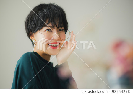 A woman in a dark green knit A woman in a dark green knit 92554258